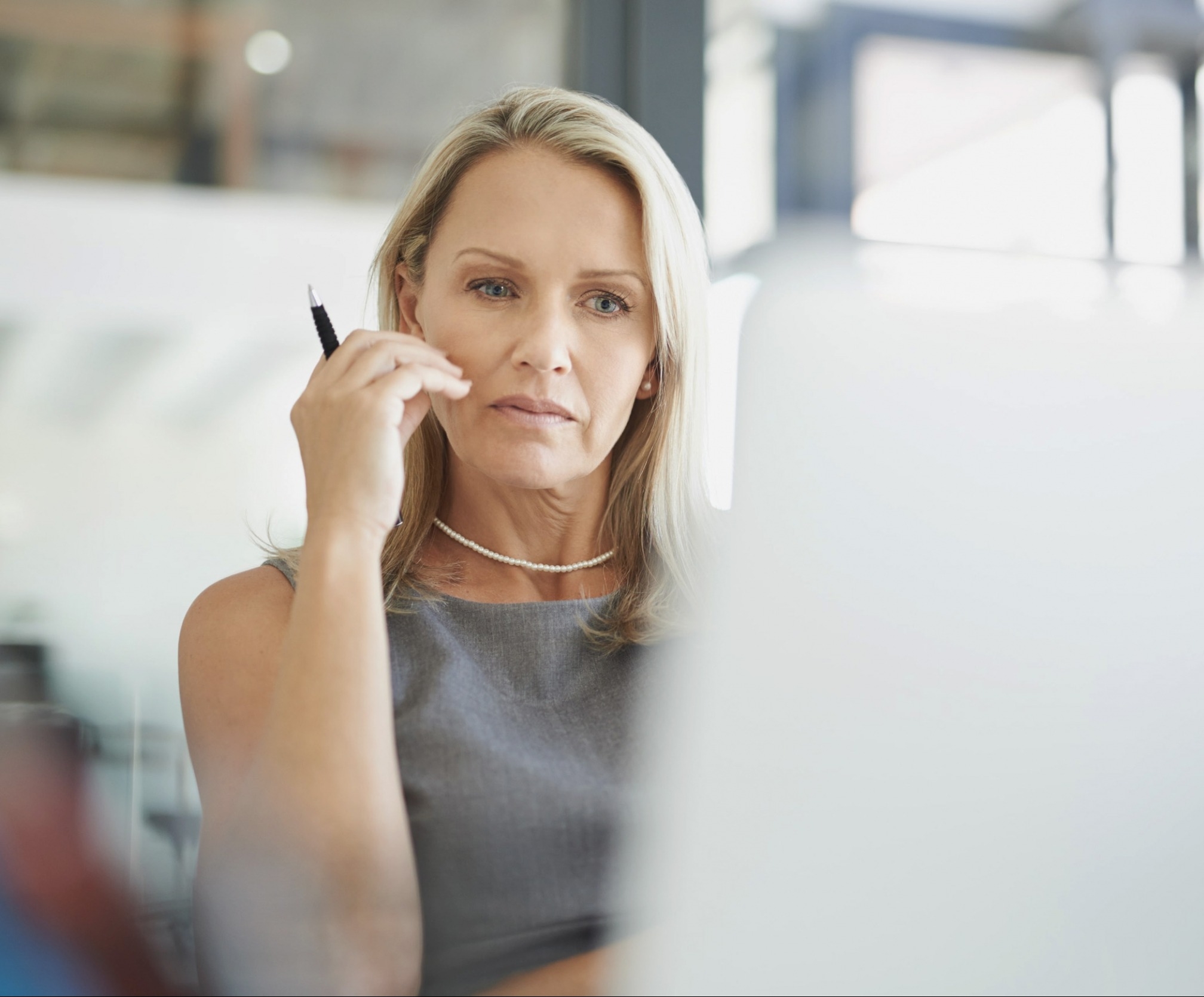 ETQ Reliance Risk management software with lady assessing risk data on laptop