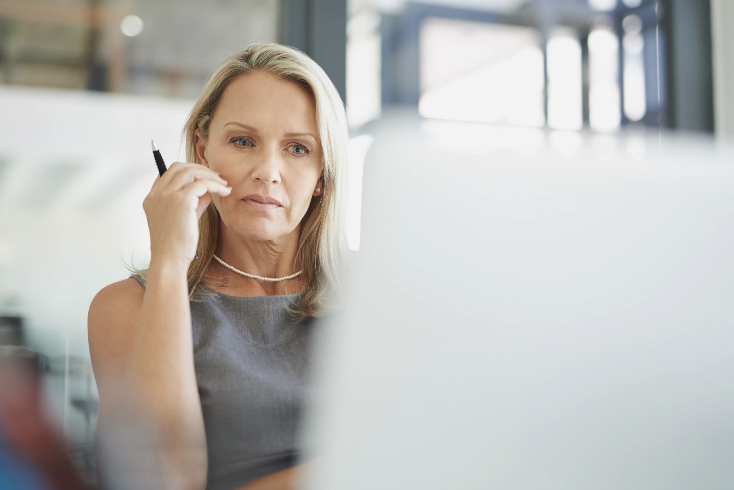 ETQ Reliance Risk management software with lady assessing risk data on laptop