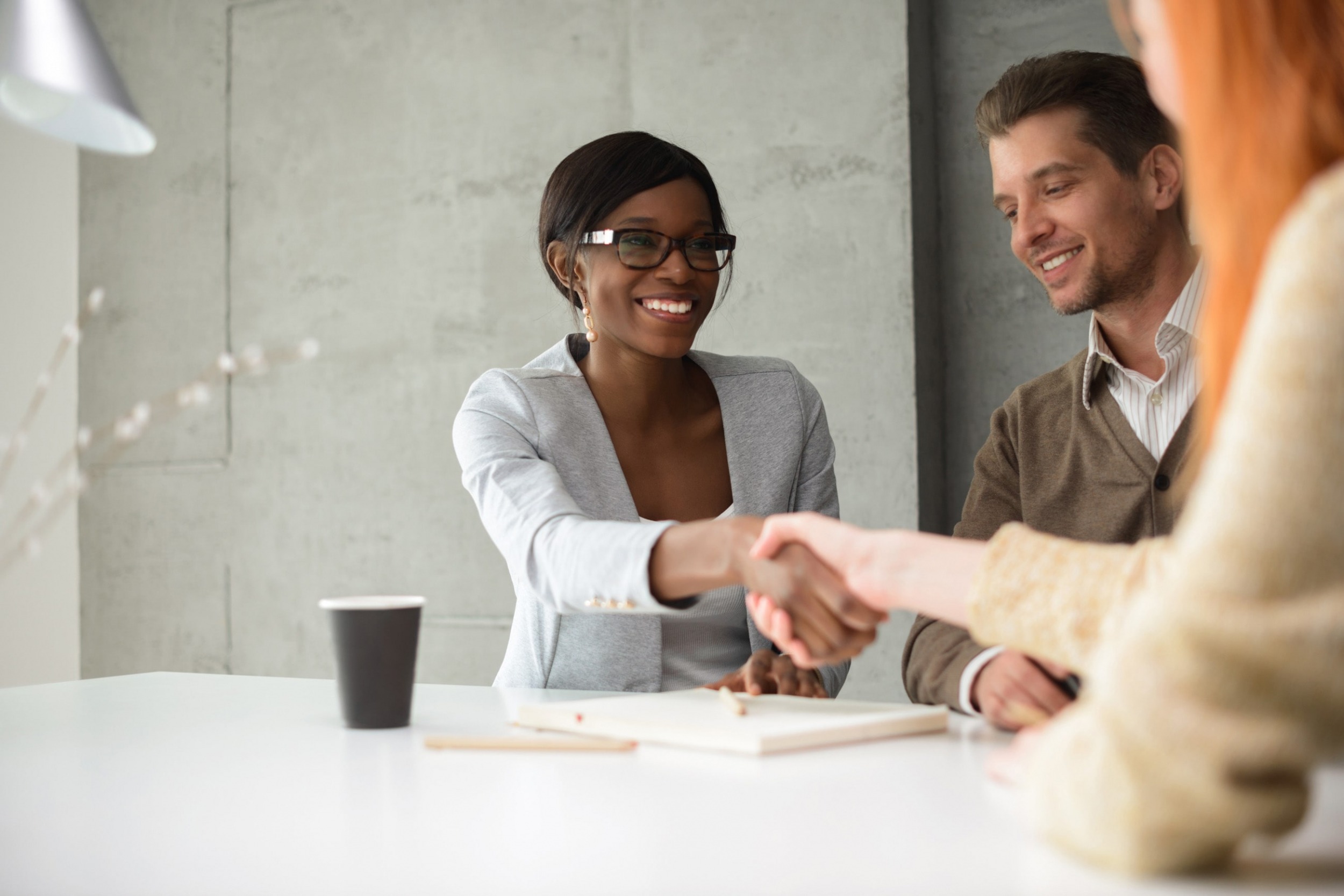 ETQ customer experience toward quality technology services with colleagues shaking hands