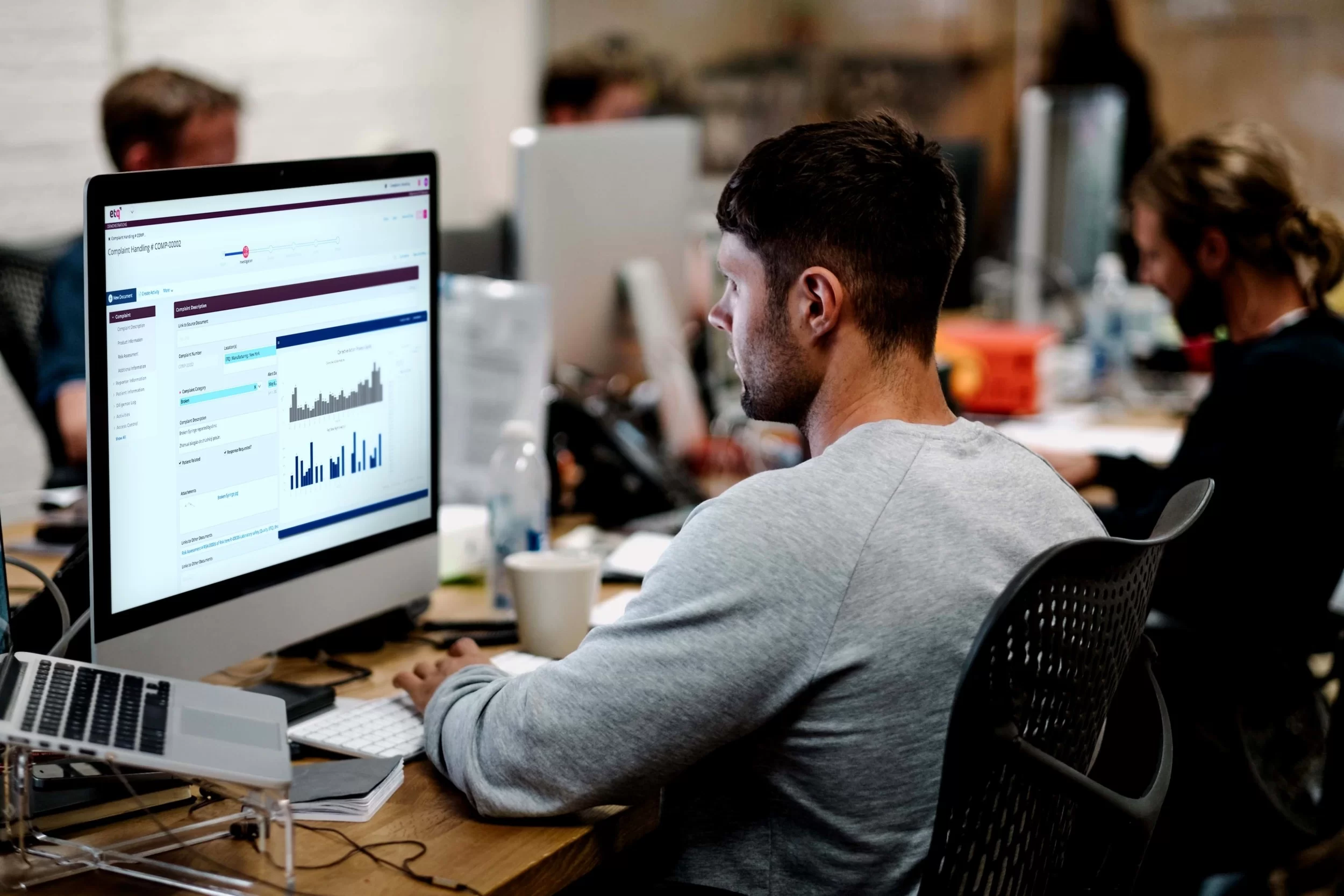 quality manager looking on his desktop at the ETQ Reliance audit management software application